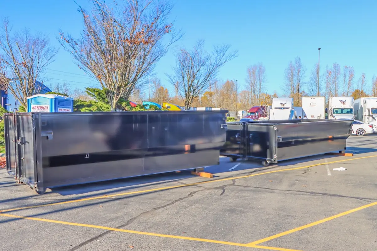 Professional dumpster rental service with roll-off container on residential driveway in South Charleston